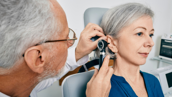 Clinician performing ear microsuction under microscope