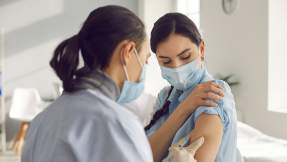 A nurse administers a flu vaccine to a patient 